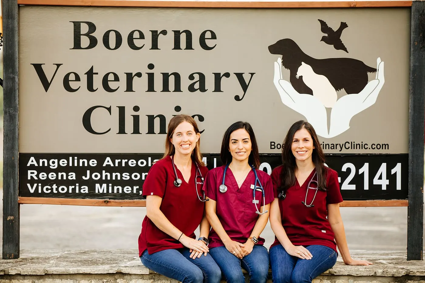 The three veterinarian owners in front of the Boerne Veterinary Clinic sign