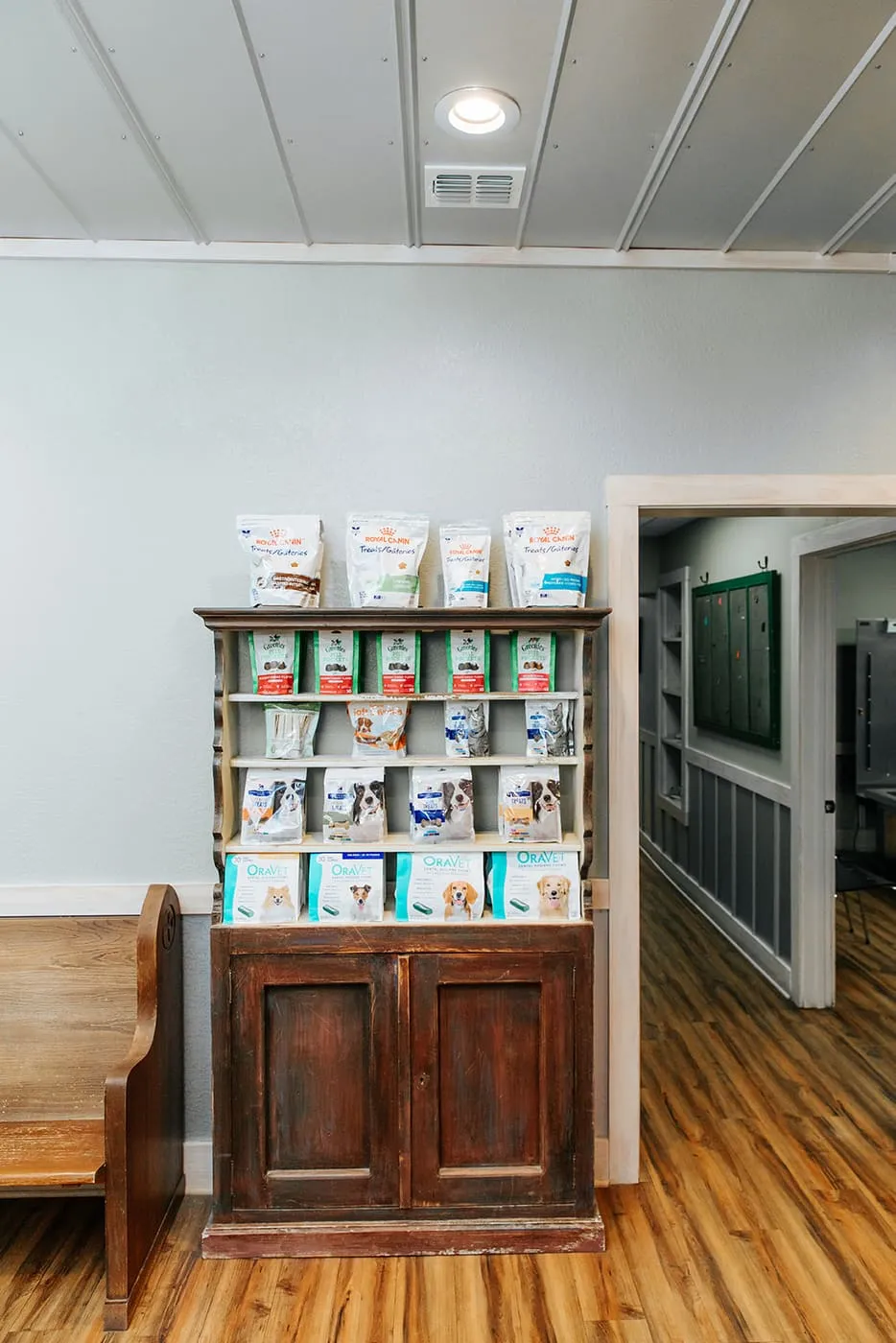 Pet food and treats on a wooden shelf in the lobby