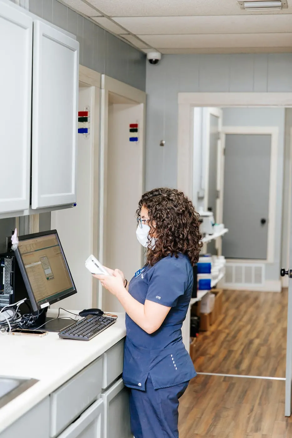 A team member reviewing a patient chart at a computer